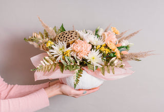 Beautiful spring flower arrangement with ranunculus carnations and roses as inspiration for choosing the best flowers for events weddings and celebrations