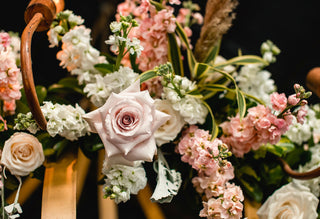 Lush wedding floral arch with pink roses peach roses white stock and eucalyptus from Bloomingmore farm-fresh flowers for any season