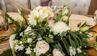 Elegant white and green fresh flower arrangement featuring white hydrangeas and lush greenery from Bloomingmore for weddings events and home decor