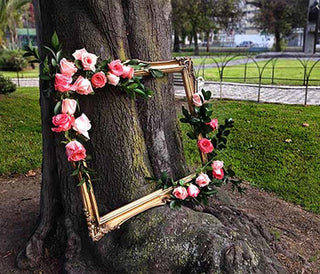 Finished DIY floral frame with fresh pink roses and ruscus greens from Bloomingmore, perfect for weddings, photo booths, and events