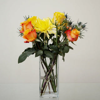 DIY fall flower bouquet with orange roses, yellow roses, yellow spider mums, and eryngium from Bloomingmore