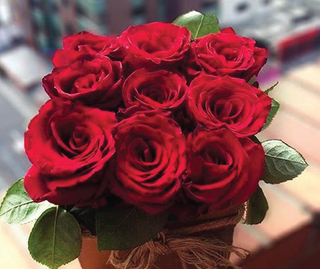 Beautiful DIY flower gift box filled with fresh roses arranged in a decorative box as an elegant and affordable floral gift