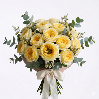 Bouquet of yellow carina garden roses with greenery eucalyptus and wax flower with white cream on a light gray white background